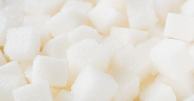 Sugar cube texture background sweet food ingredient, studio shot health high blood risk of diabetes, and calorie intake concept