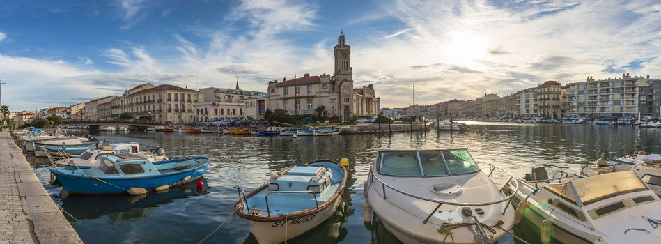 A sunrise over the Canal Royal and the Canal de la Peyrade with their boats all along in Sète in the South of France