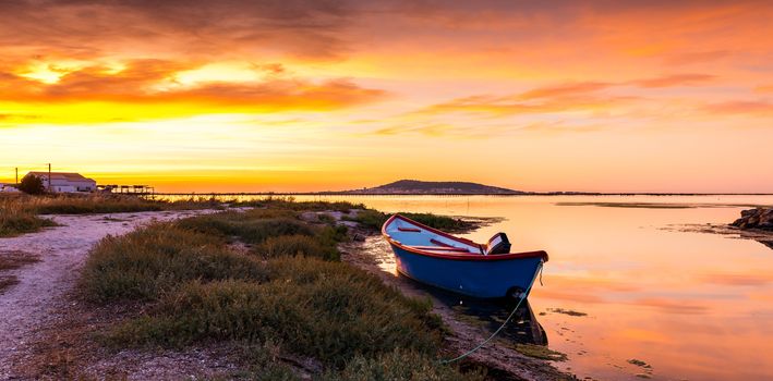 Golden and glowing color at sunrise on the Thau pond near the oyster farms near Mèze, in the Hérault department in the Occitanie region and in the south of France