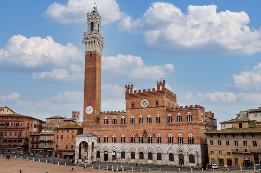 In Piazza del Campo, the central seashell-shaped square, stand the Palazzo Pubblico, the Gothic town hall, and the Torre del Mangia, a narrow 14th-century tower offering a panoramic view from its white travertine summit.