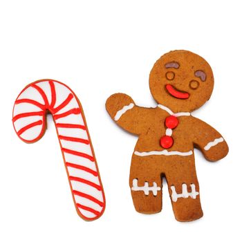 Christmas gingerbread man and candy cane decorated with color glaze isolated over white background