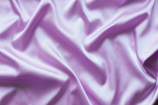 Smooth elegant lilac silk with soft folds can be used as background.