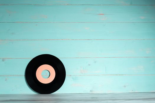 Vinyl record on wooden background,vintage style