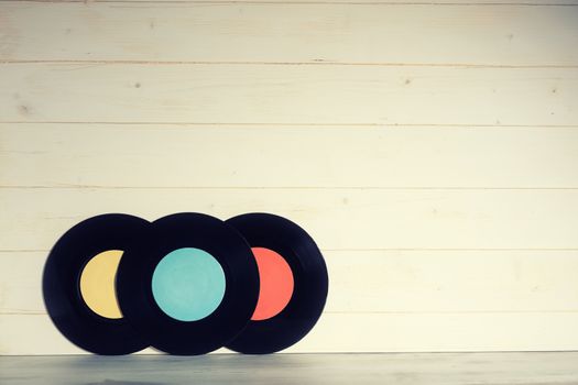 Vinyl records on wooden background,vintage style