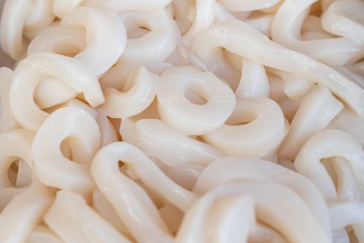 Fresh raw squid rings at seafood market