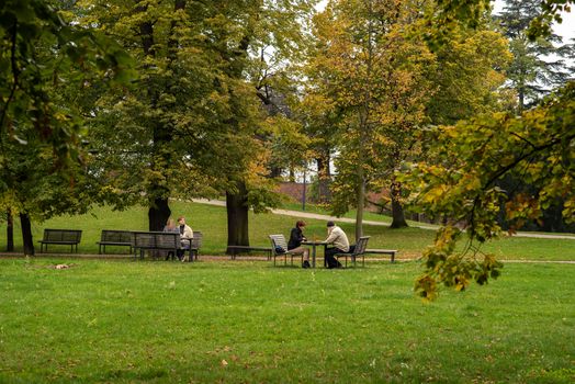 People are talking and playing chess on Letna Park in Autumn 2020 on Prague 6 during quarantine period due to outbreak of COVID-19 as winter is starting, Czech Republic