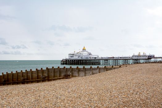 Eastbourne Pier on the southeast coast of England. The pleasure pier, opened in 1870, stretches out into the sea from a pebble beach.