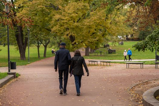Man and woman are walking and talking on Letna Park in Autumn 2020 on Prague 6, during quarantine period due to outbreak of COVID-19 as winter is starting, Czech Republic. Editorial.