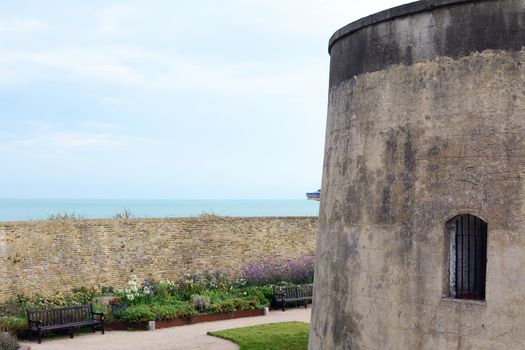 Wish Tower and pretty walled flower gardens in Eastbourne, East Sussex. The Martello Tower was built in the early 19th century to defend the English coast against Napoleon.