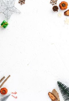 Top view of Christmas holiday decoration ornament composition with Christmas tree, gift star, gingerbread man flat lay with copy space isolated on white background.