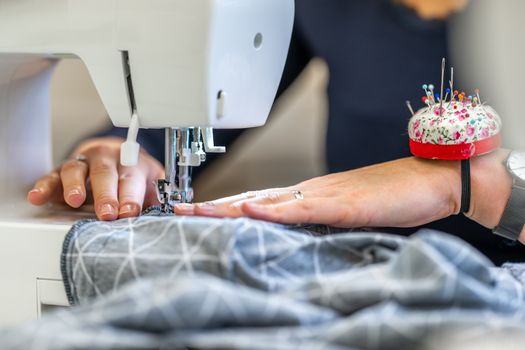 sewing cloth on a sewing machine in a tailor shop.