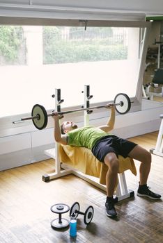 Bearded guy lifting weights at the gym