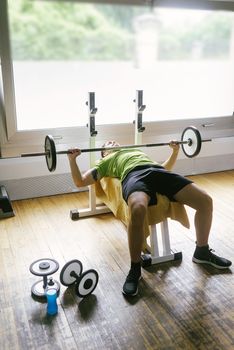 Bearded guy lifting weights at the gym