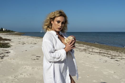 A beautiful blonde model poses nude on an exotic beach in the Yucatán Peninsula near Merida, Mexico