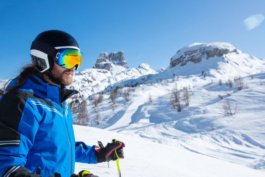 Alpine skier stand on slope in winter mountains Dolomites Italy in beautiful alps Cortina d'Ampezzo Col Gallina mountain peaks famous landscape skiing resort area