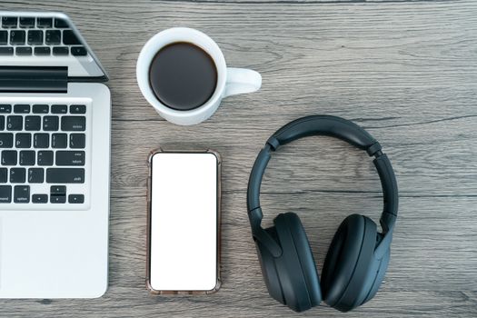 smart phone white mock up screen. Working place office desk. Flat lay workspace with laptop cup of coffee on wooden background.