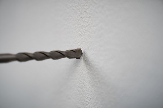 close-up of drilling machinery. Worker use drilling machine to make holes in concrete walls.