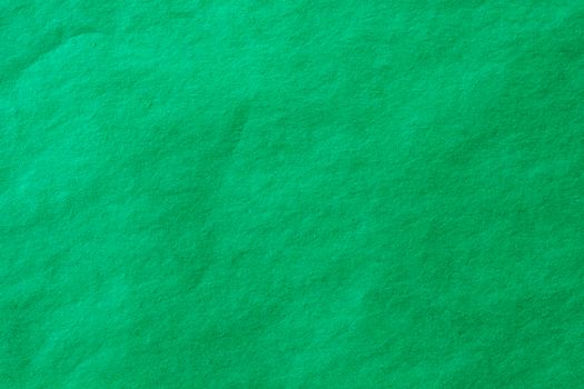 Green crumpled paper texture background.
