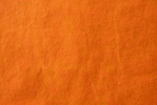 Orange crumpled paper texture background.