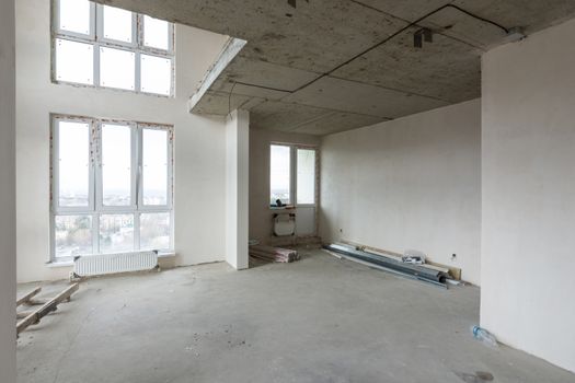 Interior of a spacious two-story apartment without renovation in a new rented house