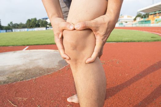 Tendon knee joint problems on Man leg from exercise In the stadium.  
