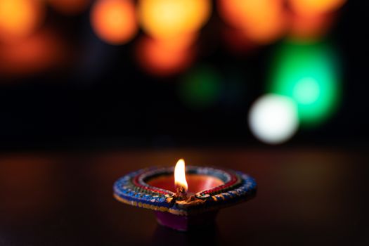Indian festival Diwali, Diya oil lamps lit on colorful rangoli. Hindu traditional. Happy Deepavali. Copy space for text.