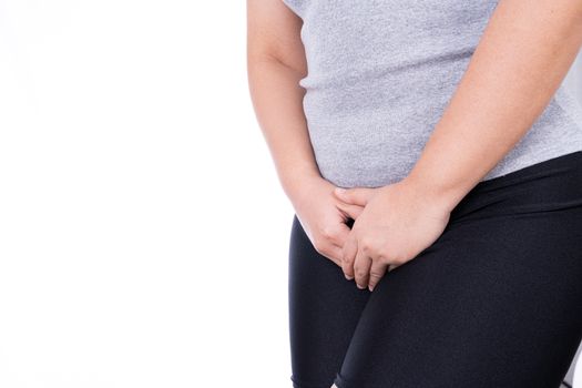 Woman hands holding her crotch suffering from painful stomachache on white background. Medical, healthcare for advertising concept.