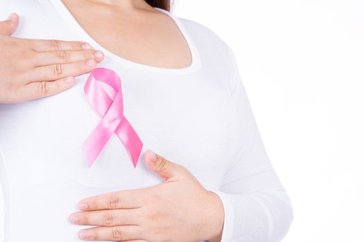 Breast cancer awareness ribbon on woman chest and doing self exam isolated over white background. Medical, healthcare for advertising concept.