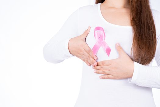 Breast cancer awareness ribbon on woman chest and doing self exam isolated over white background. Medical, healthcare for advertising concept.