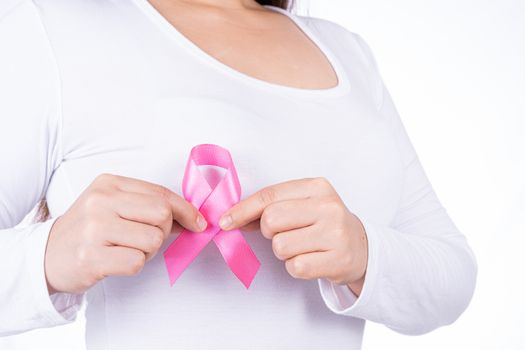 Breast cancer awareness ribbon on woman chest isolated over white background. Medical, healthcare for advertising concept.