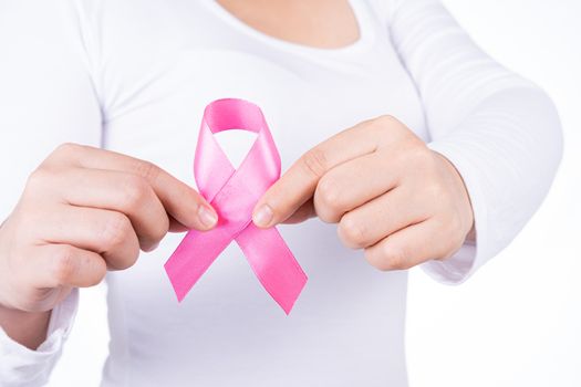 Breast cancer awareness ribbon on woman chest isolated over white background. Medical, healthcare for advertising concept.