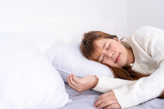 Asian woman sleeping in the bed and relaxing in a good mood happy dream. Healthcare medical or daily life concept.