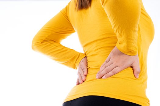 Woman suffering from waist and back pain isolated white background. Health care and medical concept.