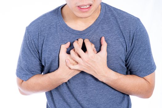 Man touching his heart or chest isolated white background. Healthcare medical or daily life concept.