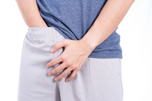 Man hands holding his crotch isolated white background. Medical, healthcare for advertising concept.