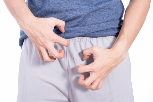 Man hands scratching his crotch isolated white background. Medical, healthcare for advertising concept.