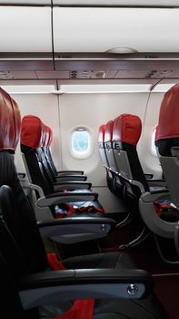 Deserted aircraft interior, empty passenger seats.