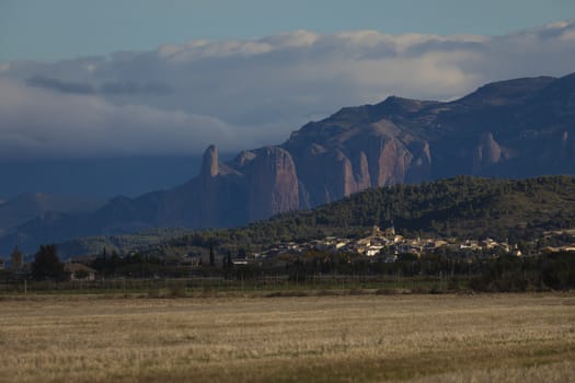 Biscarrues, Spain - October 15, 2020: General view of the town of Biscarrues, province of Huesca, Pre-Pyrenees Aragon. In the background, big mountain of Mallets of Riglos.