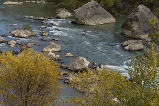 Waters of the Gallego river in autumn, almost winter, meandering between rocks and nooks, in the Aragonese Prpyrenees, as it passes through the municipality of Riglos.