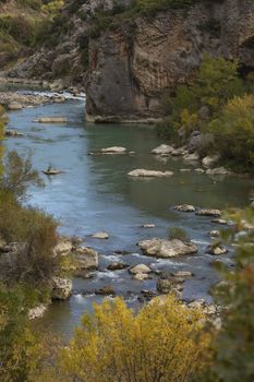 Waters of the Gallego river in autumn, almost winter, meandering between rocks and nooks, in the Aragonese Prpyrenees, as it passes through the municipality of Riglos.