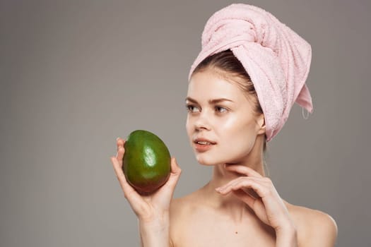 Pretty woman bare shoulders mango Exotic tropics skin care. High quality photo