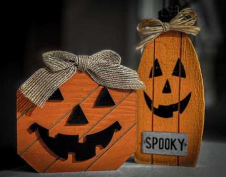 A Homemade Jack O' Lantern Halloween Decoration Made of Wood and Paint