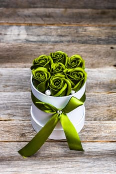 Green roses in a round luxury present box. Bouquet of flowers in a paper box isolated.