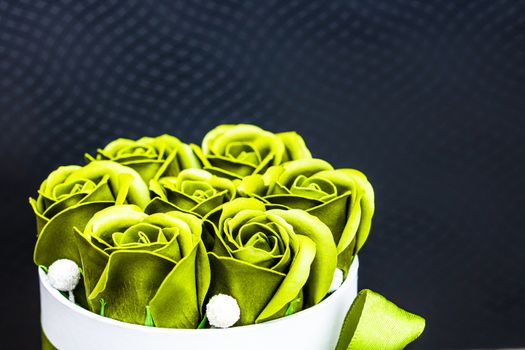 Green roses in a round luxury present box. Bouquet of flowers in a paper box isolated.