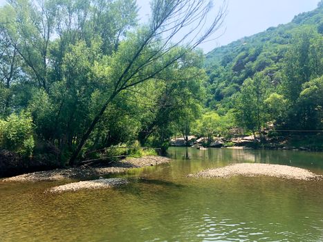 Small river running in the forest next to mountain, located in Minyun, natural reserve water, Beijing, China