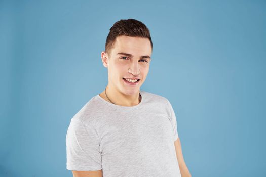 Emotional man in white t-shirt cropped view on blue background lifestyle. High quality photo