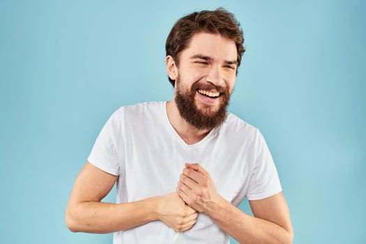 Cheerful man gesturing with his hands emotions cropped view on blue background studio. High quality photo