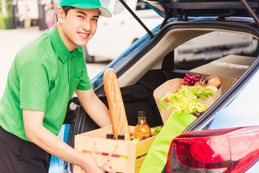 Asian delivery man grocery prepare service giving fresh vegetables food and fruit full in wooden basket on back car to send woman customer at door home after pandemic coronavirus, Back to new normal