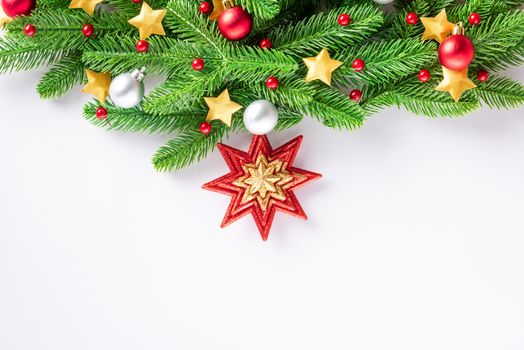 Christmas garland fir tree branches decorated balls and confetti stars, top view overhead festive Xmas decoration and ornaments isolated on white background, New year card concept