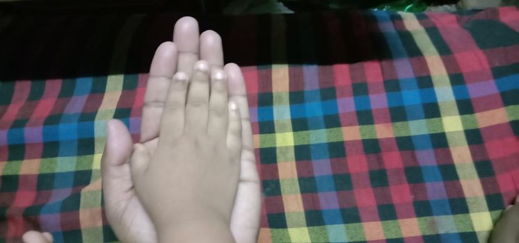 child and father hand closeup with trust